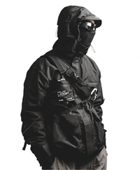 A person wearing a black cyberpunk jacket with a hood and goggles, featuring multiple pockets and YKK zippers.