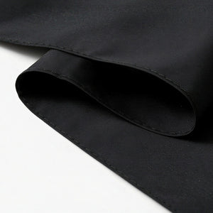 Close-up of the black umbrella fabric and stitched hem