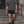 Man walking down stone steps in the Black 2-in-1 running shorts and a grey tee, front view with drawstring