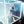 Person in futuristic outfit standing inside a glowing cube with digital patterns.