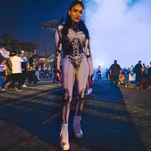 Person in a detailed costume with a skeleton design at an outdoor event.