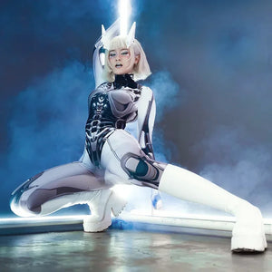 Person in a futuristic, white and black costume with glowing elements on a dark background