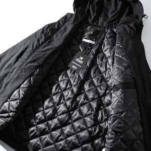 Black quilted jacket with a brand tag on a white background
