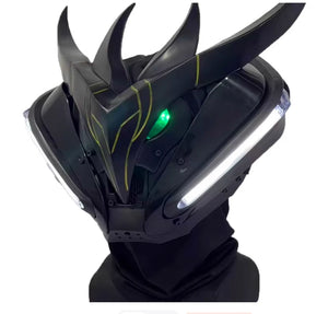 Black futuristic helmet with glowing green eyes and white lights on a white background