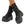 Black platform boots with multiple straps on a neutral background