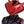 Close-up of a red and black robot helmet with intricate design on a white background