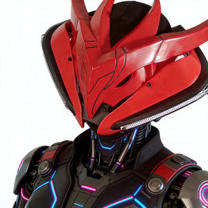 Close-up of a red and black robot helmet with intricate design on a white background
