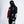 Person wearing a black and red racing suit with various logos on a white background