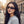 Woman wearing futuristic sunglasses on a city street