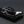 Black and silver futuristic sunglasses on a dark gray background