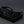 Black sunglasses on a black stand against a dark background