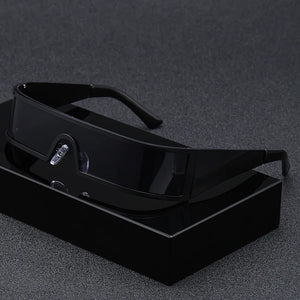 Black sunglasses on a black stand against a dark background