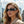 Woman wearing futuristic sunglasses with a cityscape background