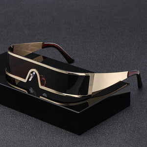 Gold-framed sunglasses on a black stand with a dark background