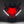 Dragon head mask with red glowing eyes and white accents on a dark background