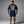 Person wearing a navy blue t-shirt with 'Cyber Iron Club' design on the back against a gray background