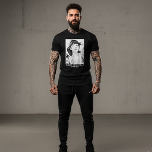 Man wearing a black t-shirt with a graphic design, standing against a plain background