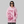 Person wearing a pink hoodie with graphic design on a gray background