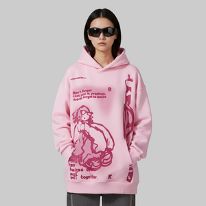 Person wearing a pink hoodie with graphic design on a gray background