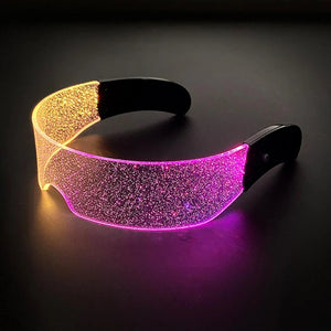 Glowing headband with yellow and pink glittery sections on a dark background