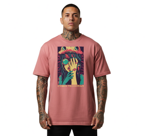 Man wearing a pink t-shirt with a colorful graphic design on a plain background