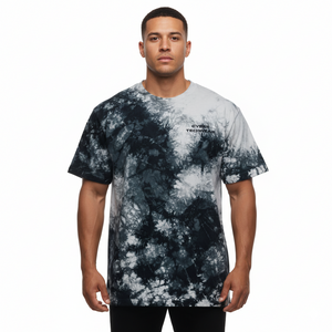 Man wearing a tie-dye t-shirt with a visible brand logo on a white background