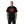 Person wearing a black t-shirt with red text on a white background