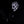 Person wearing a detailed mask with white and black design, against a dark background