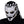Person wearing a white and black mask with intricate design on a white background