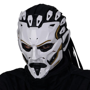Person wearing a white and black mask with intricate design on a white background