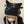 Black cat ear hat with decorative elements worn by a person against a neutral background