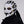 Person wearing a futuristic white and black mask with gold accents on a plain background