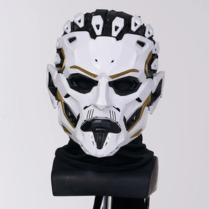 White and black mask with gold accents on a gray background