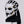 White and black mask with gold accents on a mannequin head against a white background