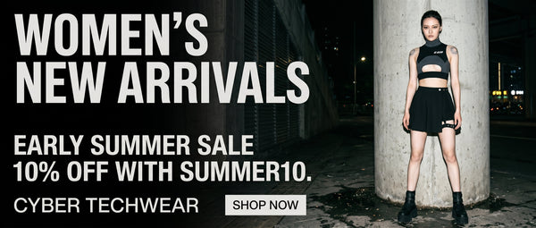 Woman in black cyber techwear standing against a wall with promotional text for women's new arrivals and a sale.
