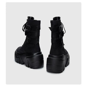 Black platform boots with thick sole on a white background