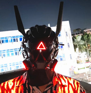 Black techwear mask with tall antenna blades and a red triangle indicator