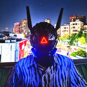 Black techwear mask with tall antenna blades and a red triangle indicator