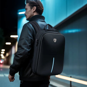 Black backpack with a moulded armoured shell front and a top grab handle