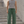 Man in Dark Green Baggy Barrel Leg Sweatpants and a gray tank top, front view on concrete steps