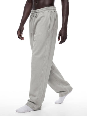 Light Gray barrel leg sweatpants on a walking model, side view of the relaxed fit and stacked hem