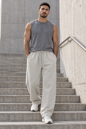 Light Gray barrel leg sweatpants worn front view, hands in pockets, drawstring waist and white sneakers