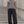 Black baggy barrel leg sweatpants on a man standing on steps, front view with the dark drawstring