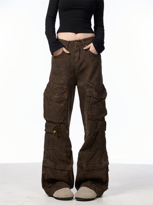 Front view of the washed brown cargo pants with hands in the front pockets and snap flap pockets