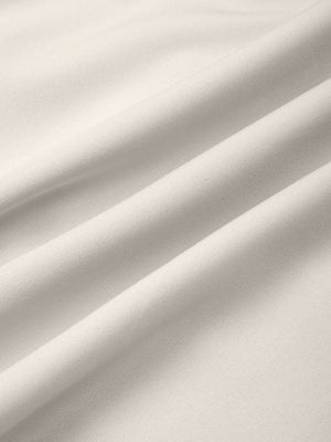 Pale Khaki woven fabric of the workout shorts in soft folds, smooth surface with a slight sheen
