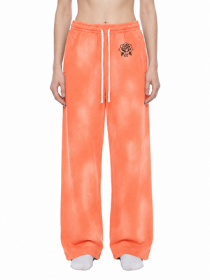 Orange Baggy Sun Faded Y2K Sweatpants worn from the front, mottled vintage wash and white drawstring
