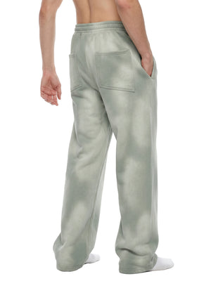 Light Gray sweatpants worn in a back three-quarter view, hand in the side pocket, loose wide leg cut