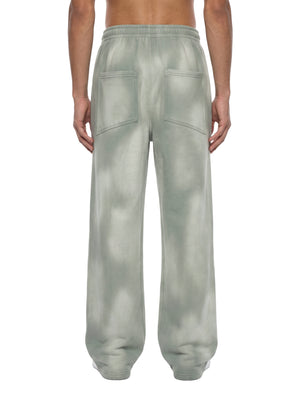 Back view of the Light Gray baggy sweatpants on a model, with both patch pockets and the elastic waist