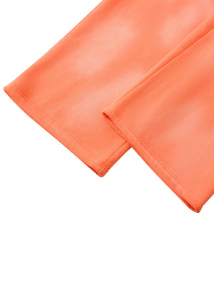 Detail of the straight open hem on the Orange wide leg sweatpants, showing the sun faded colour