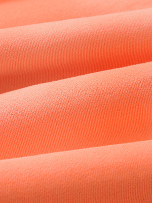 Close-up of the Orange sun faded fabric on the sweatpants, showing the cloudy, uneven vintage wash